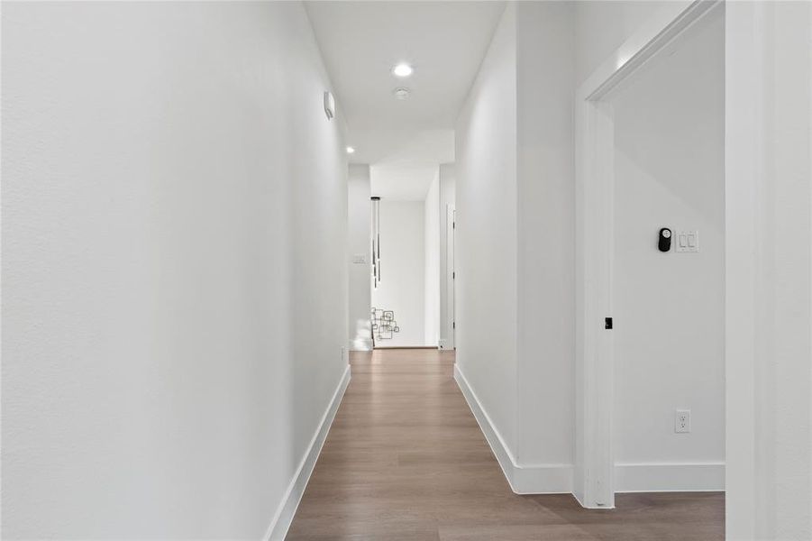 Hallway featuring wood finished floors and recessed lighting