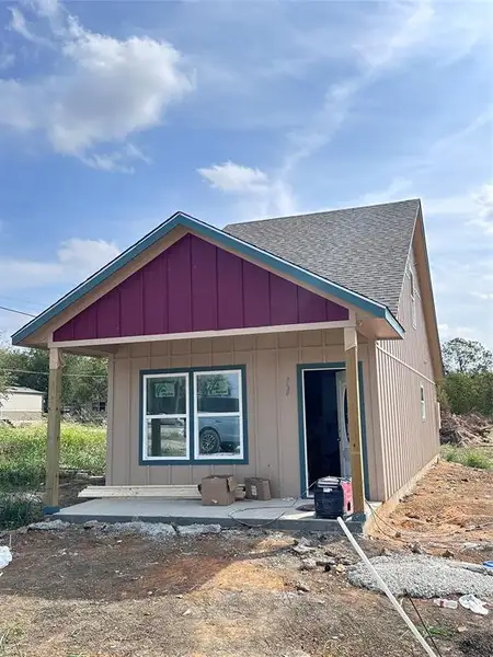 View of front of house with roof with shingles, covered porch, and board and batten siding