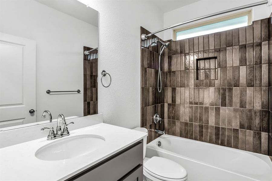 Bathroom featuring a single vanity with an integrated sink, polished chrome fixtures, and a large mirror