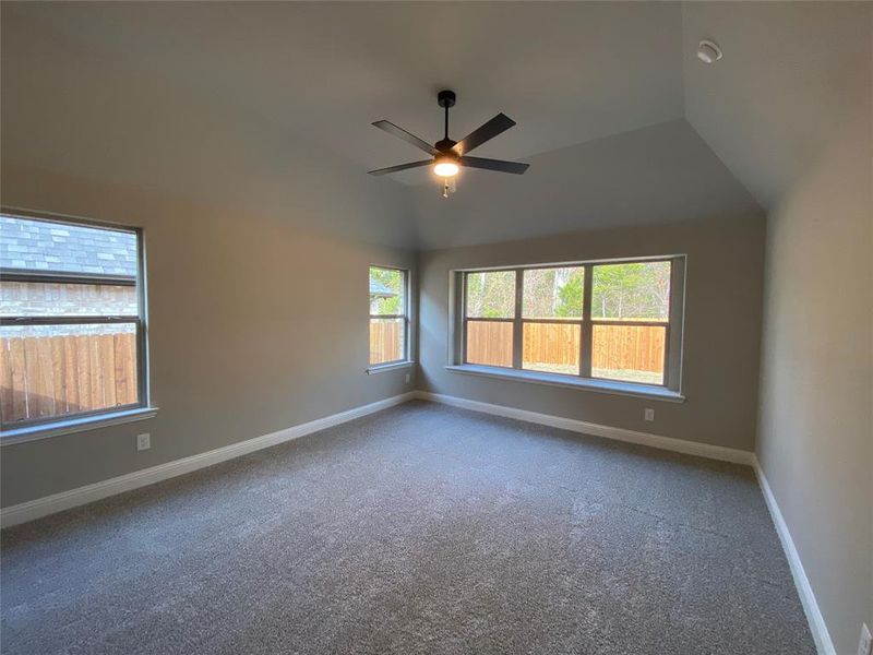 Master bedroom offers vaulted ceiling, lots of windows, and ceiling fan Master bedroom offers vaulted ceiling, lots of windows, and ceiling fan