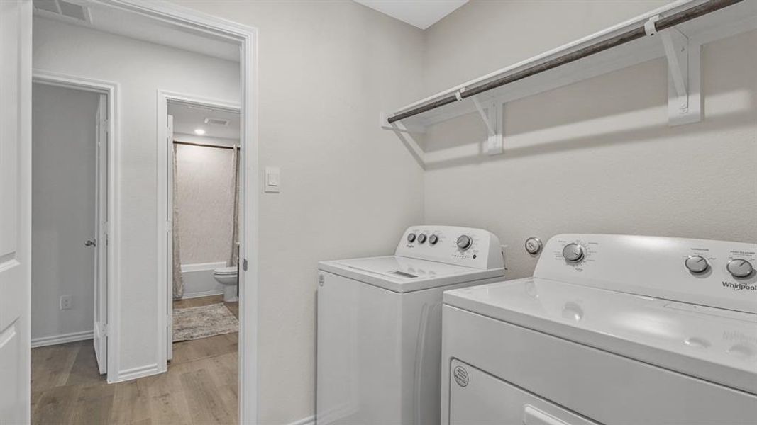 Dedicated laundry area featuring a white top-load washer and front-load dryer
