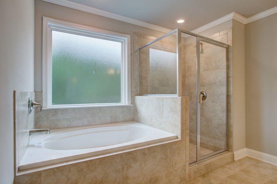 The master suite includes a private bath and walk in shower