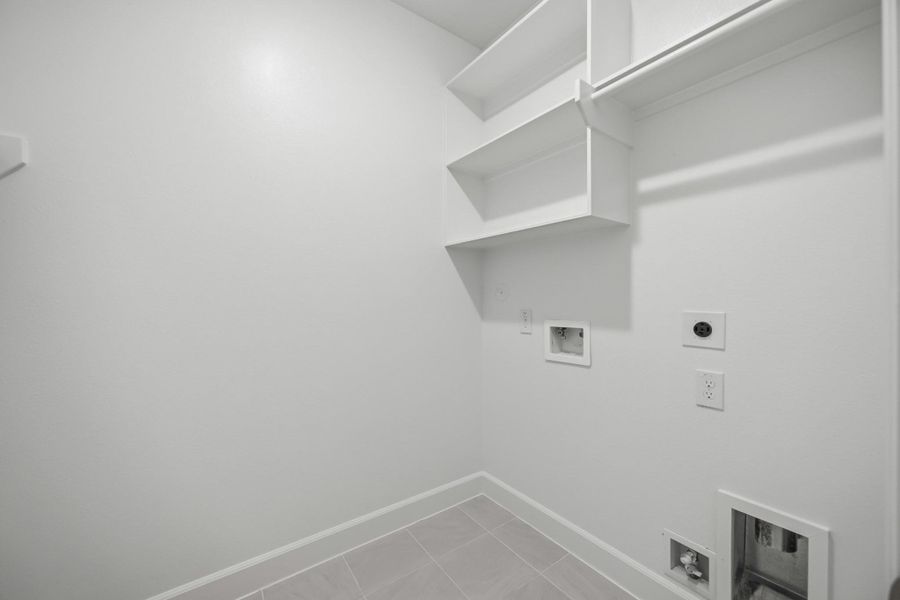 Clean design meets clever function in this dedicated laundry room. With built-in shelving and plenty of space to fold, it actually makes chores feel…doable. Clean design meets clever function in this dedicated laundry room. With built-in shelving and plenty of space to fold, it actually makes chores feel…doable.