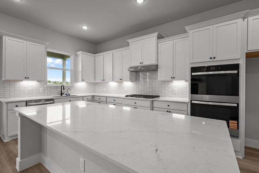 A kitchen with white cabinets. A kitchen with white cabinets.