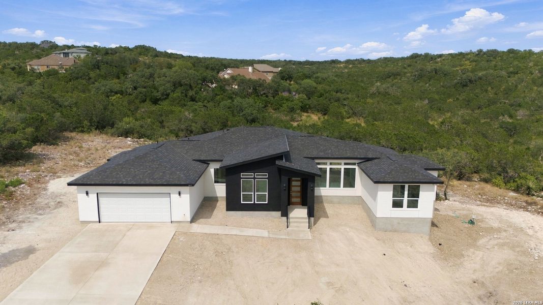 Front exterior of a new home in , Mico, TX, highlighting curb appeal (Image 25).