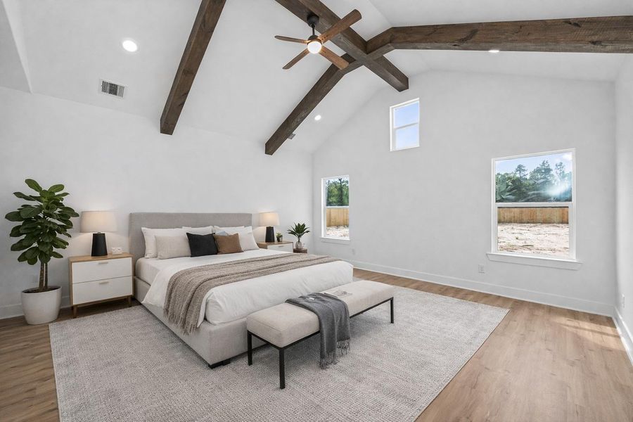 Oversized primary suite featuring vaulted ceilings with wood beam accents and plenty of natural light. Virtually Staged.