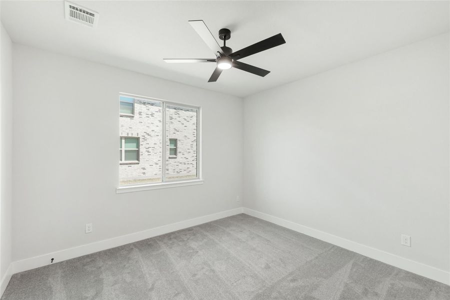 Empty bedroom with gray carpet, white walls, ceiling fan, and single window Empty bedroom with gray carpet, white walls, ceiling fan, and single window
