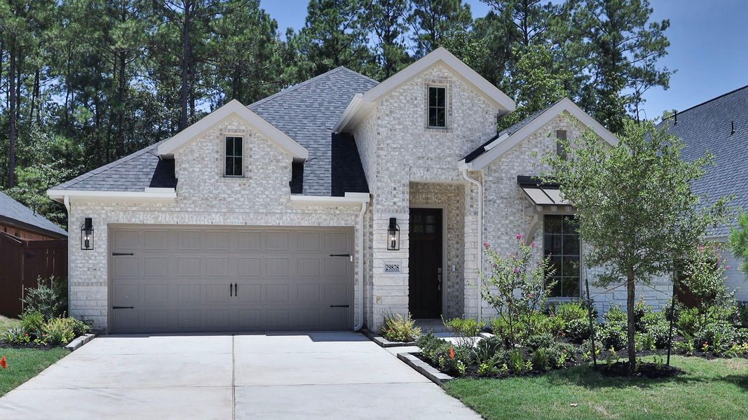 Front exterior of a new home in Woodhavyn, Magnolia, TX, highlighting curb appeal (Image 2).