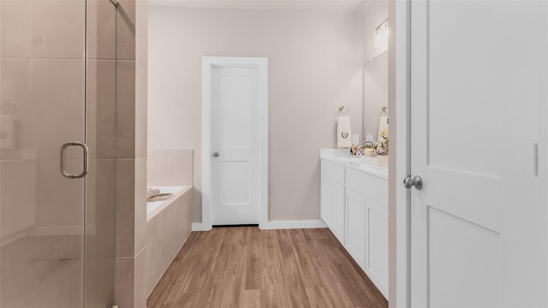 The Primary bath features a large walk in shower, large soaking tub and high double vanity cabinets.