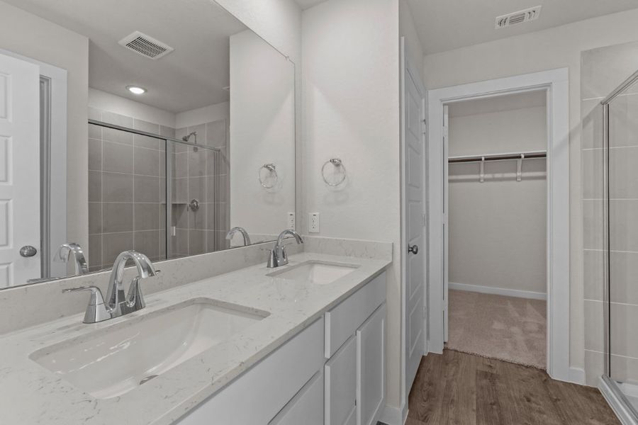 A bathroom with a glass shower. A bathroom with a glass shower.