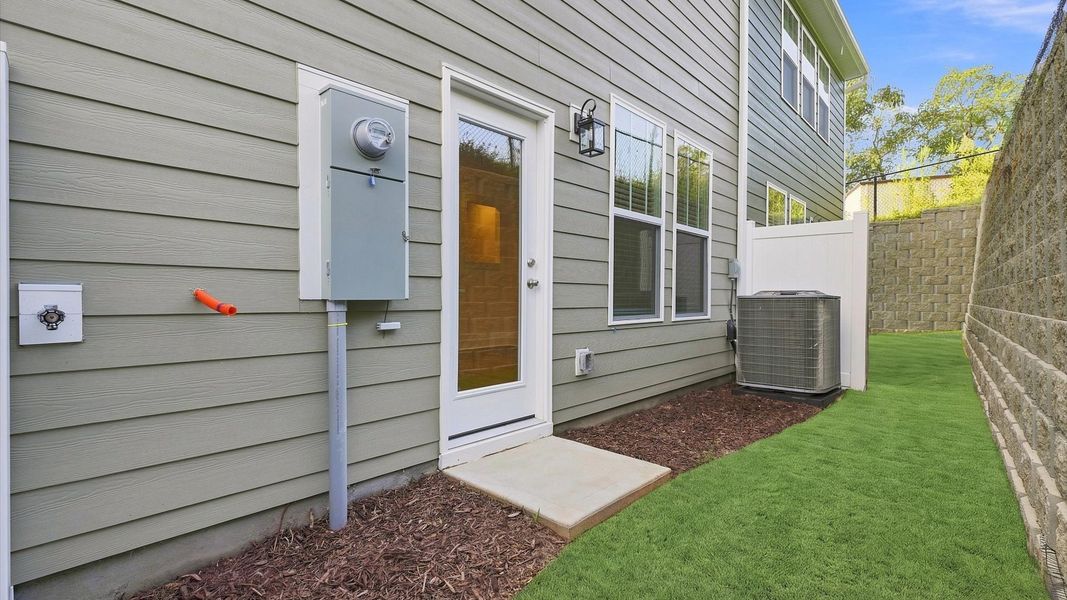 Stately rear elevation with privacy and polished landscaping located in Arden, NC