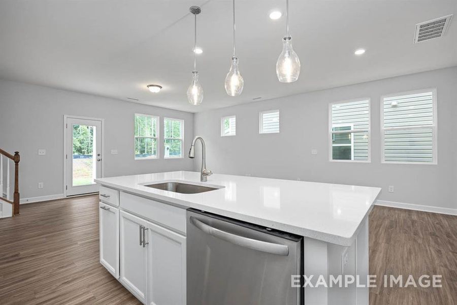 Kitchen with a kitchen island with sink, sink, wood-type flooring, dishwasher, and white cabinetry