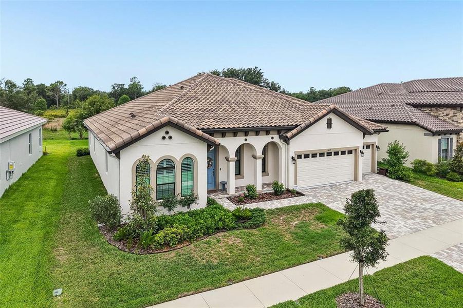Front exterior of a new home in Hawkstone, Lithia, FL, highlighting curb appeal (Image 23).