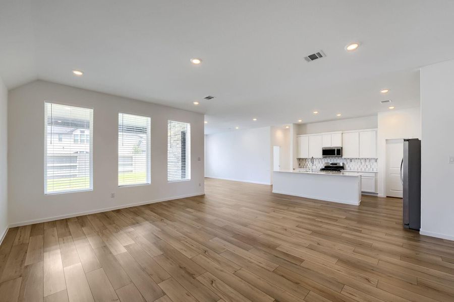 Experience the elegance of LVP flooring and bask in abundant natural light streaming through expansive windows.