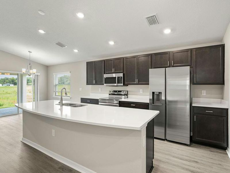 Your bright, open kitchen includes quartz, 36-inch cabinets, Samsung SS appliances, and a walk-in pantry. Your bright, open kitchen includes quartz, 36-inch cabinets, Samsung SS appliances, and a walk-in pantry.