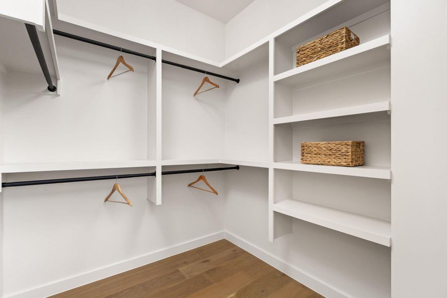 Ample shelving and hanging space defines this well-organized walk-in closet.