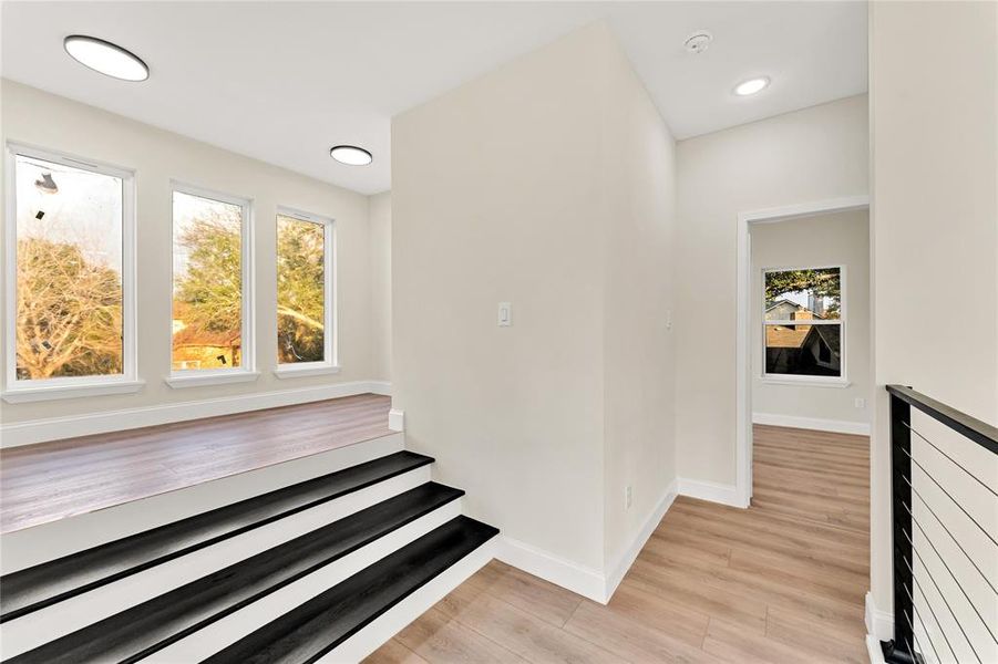 Stairs with hardwood / wood-style flooring