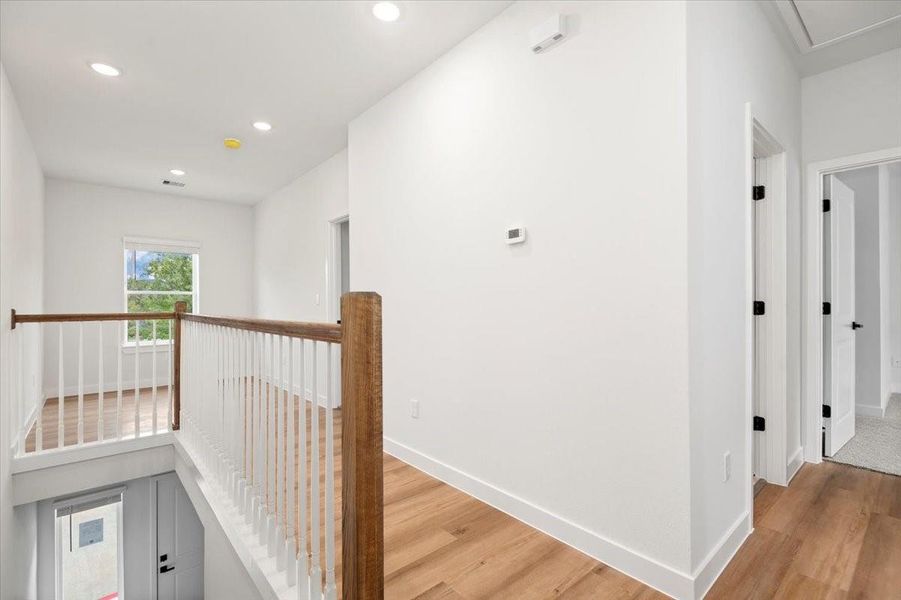 Smooth flow from hallway to primary retreat, guest rooms, office/den area and utility room.