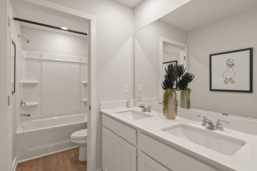 A bathroom with a sink toilet and a shower.