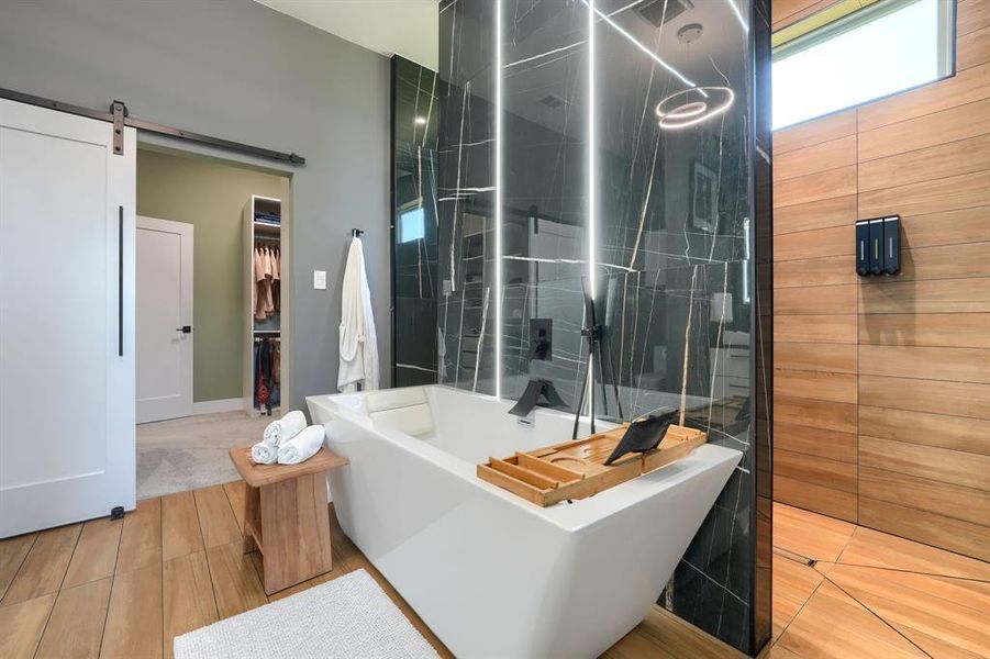 Full bath featuring a freestanding tub, a spacious closet, and a walk in shower Full bath featuring a freestanding tub, a spacious closet, and a walk in shower