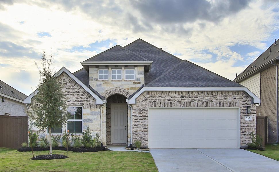 Front exterior of a new home in Brookewater, Rosenberg, TX, highlighting curb appeal (Image 1). Front exterior of a new home in Brookewater, Rosenberg, TX, highlighting curb appeal (Image 1).
