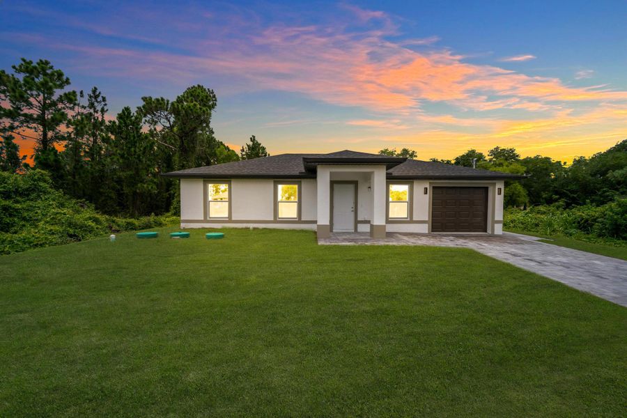 Front exterior of a new home in , Lehigh Acres, FL, highlighting curb appeal (Image 19). Front exterior of a new home in , Lehigh Acres, FL, highlighting curb appeal (Image 19).
