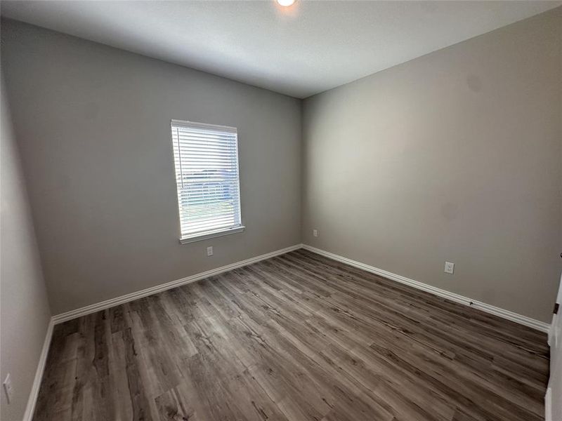 Unfurnished room with dark wood-type flooring