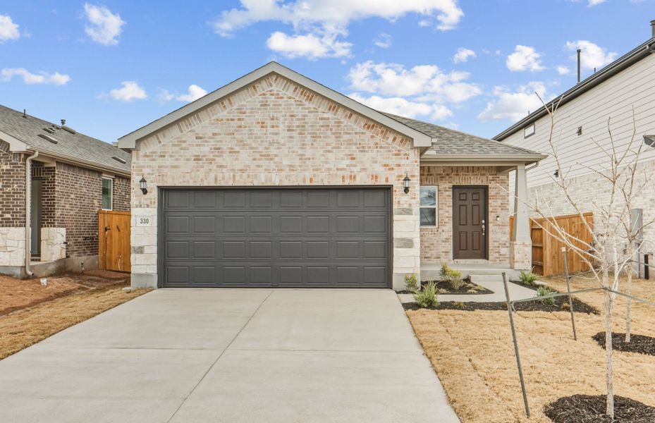 Front exterior of a new home in Crosswinds, Kyle, TX, highlighting curb appeal (Image 18).