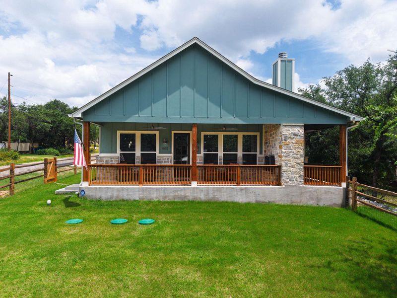 Frontage with a welcoming porch and vibrant green lawn.