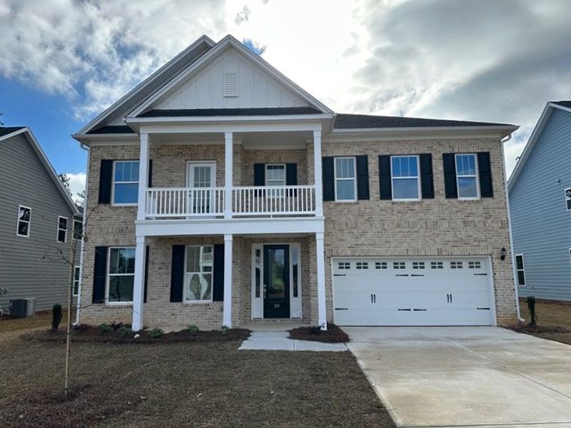 Front exterior of a new home in Pebble Branch, Chapin, SC, highlighting curb appeal (Image 1). Front exterior of a new home in Pebble Branch, Chapin, SC, highlighting curb appeal (Image 1).