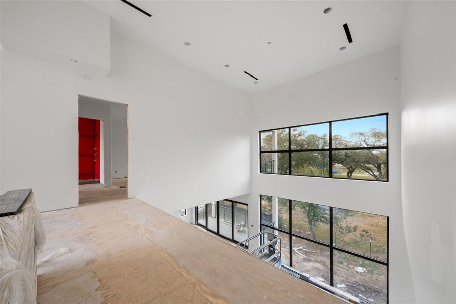 The second floor landing looks down from the 26 foot open grand entry.