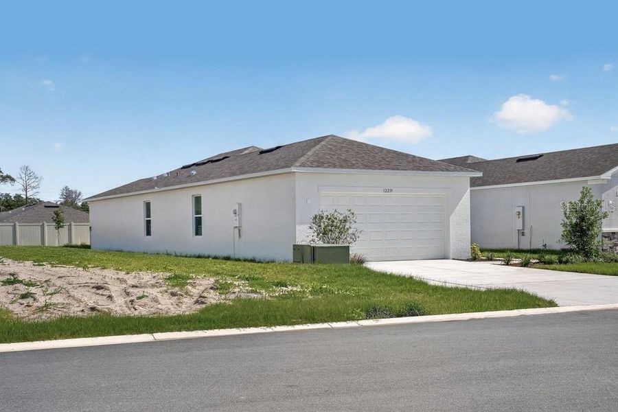 Front exterior of a new home in Palm Wind, Hudson, FL, highlighting curb appeal (Image 20).