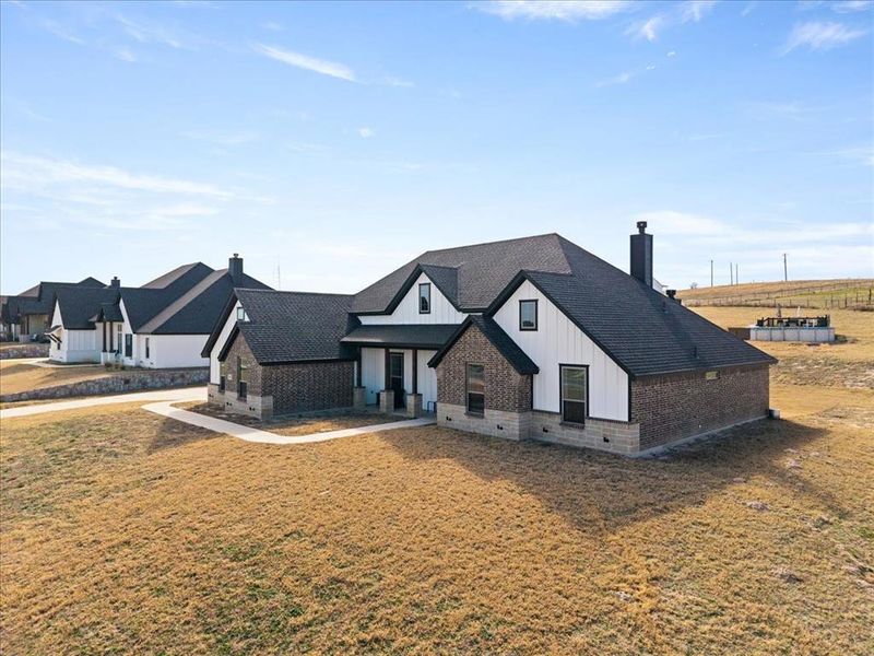 Front exterior of a new home in , Springtown, TX, highlighting curb appeal (Image 25).
