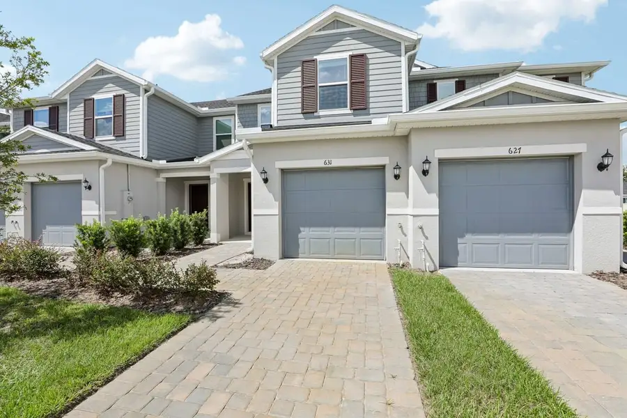 Front exterior of a new home in Reserve at Forest Lake Townhomes, Lake Wales, FL, highlighting curb appeal (Image 1). Front exterior of a new home in Reserve at Forest Lake Townhomes, Lake Wales, FL, highlighting curb appeal (Image 1).