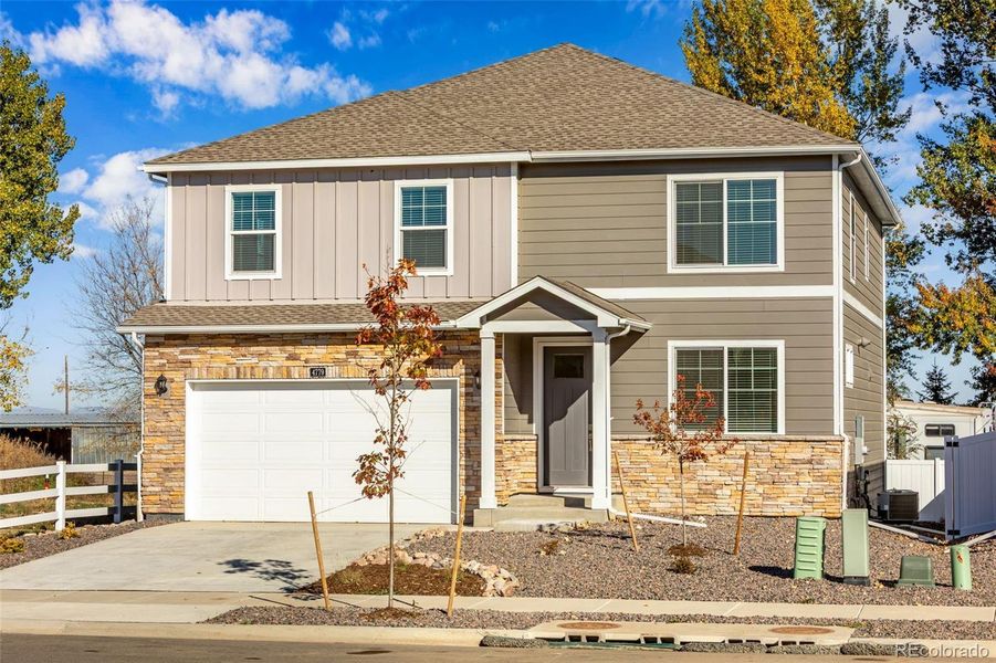 Front exterior of a new home in Sky Ranch, Watkins, CO, highlighting curb appeal (Image 1).