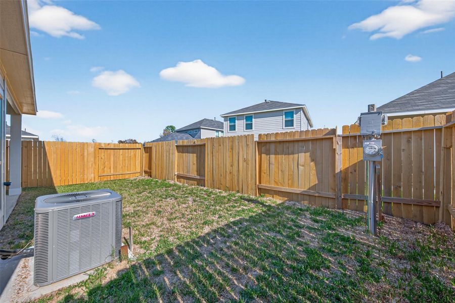 Exterior details and patio area of a home in Woodland Lakes, Huffman (Image 28).