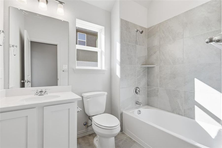 Full bathroom featuring bathing tub / shower combination and vanity Full bathroom featuring bathing tub / shower combination and vanity