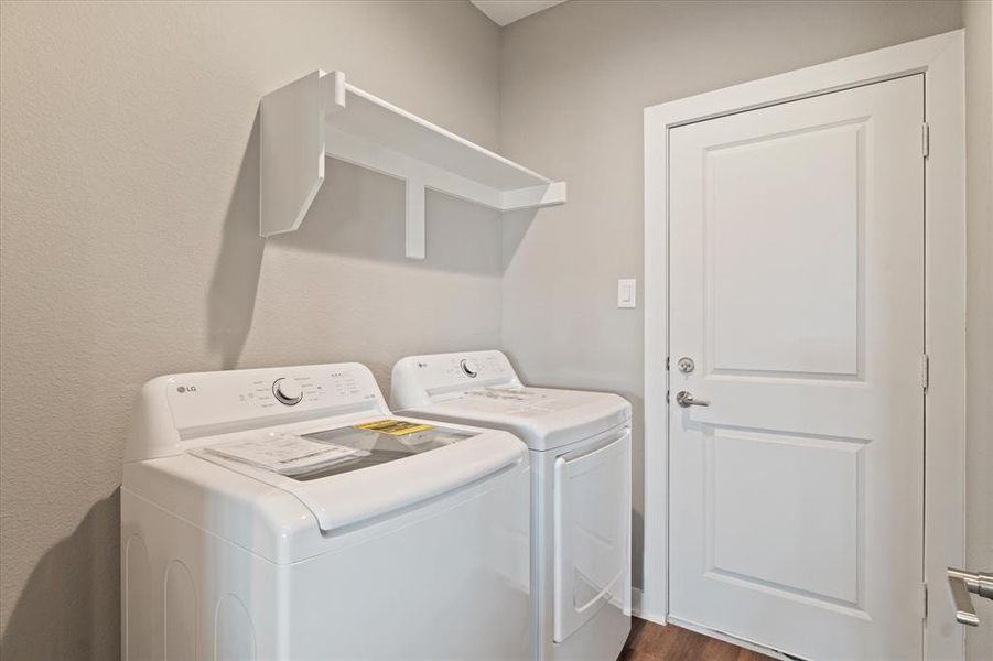 Laundry room with washer and clothes dryer and dark wood-type flooring Laundry room with washer and clothes dryer and dark wood-type flooring