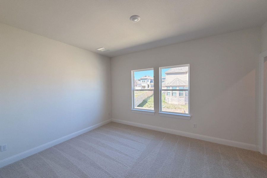 Spare room with light colored carpet and baseboards