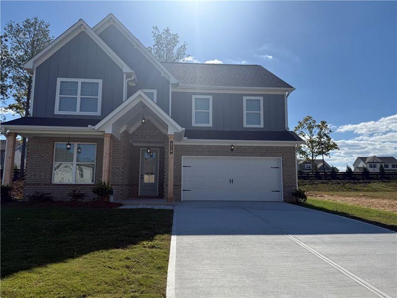 Front exterior of a new home in The Fairways at Mirror Lake, Villa Rica, GA, highlighting curb appeal (Image 1).