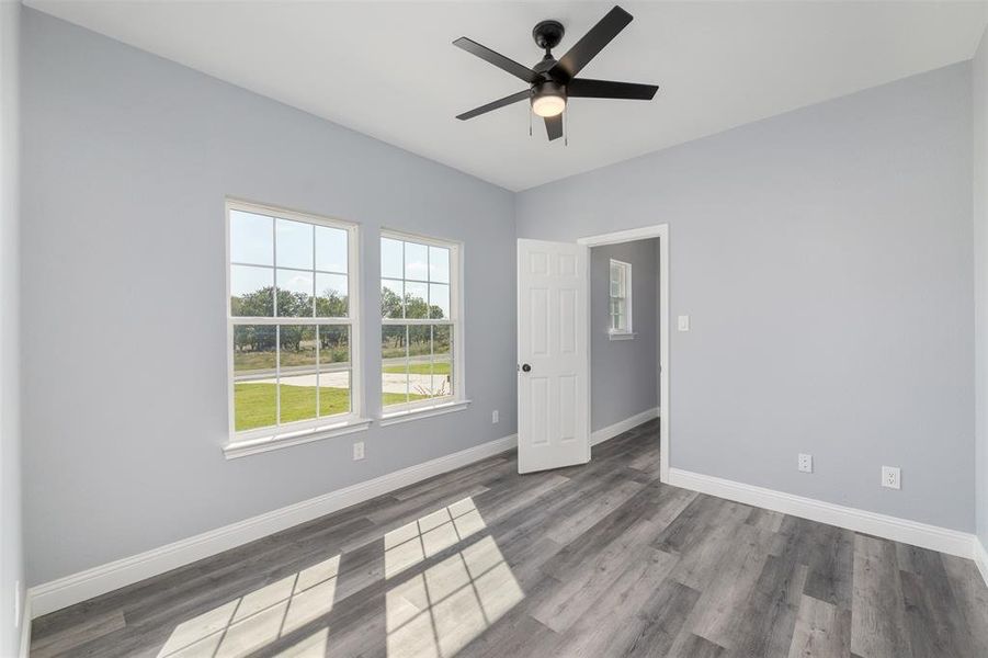 Spare room featuring wood finished floors and ceiling fan Spare room featuring wood finished floors and ceiling fan