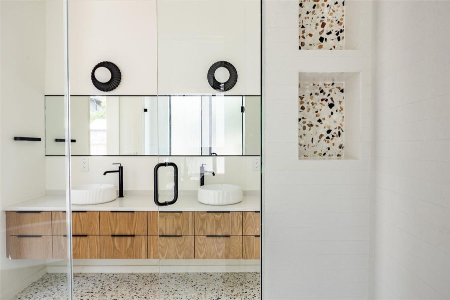Bathroom with double vanity and speckled floor