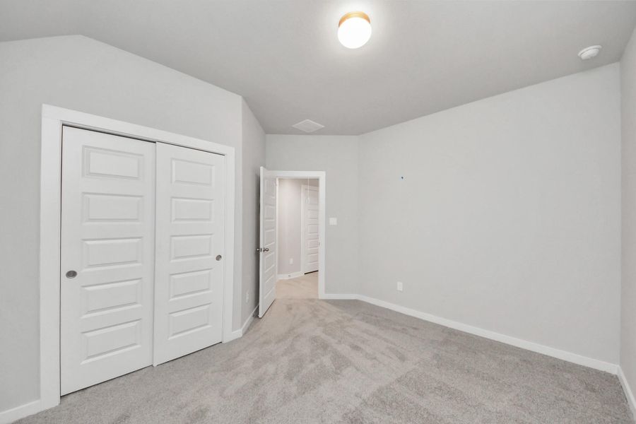 Generously sized secondary bedrooms featuring spacious closets, soft and inviting carpeting underfoot, large windows allowing plenty of natural light, and the added touch of privacy blinds for your personal retreat.