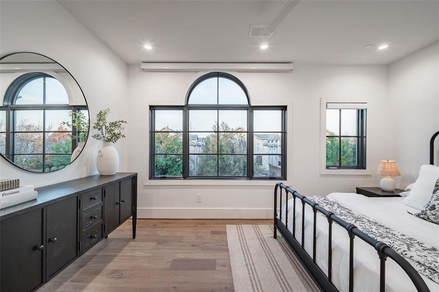 Living room with a fireplace and light wood-type flooring