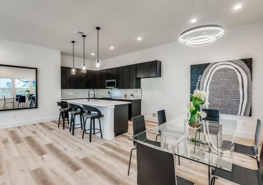 Dining area with sink and light wood-type flooring