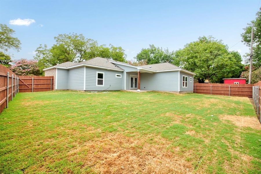 Rear view of house featuring a fenced backyard, a patio, and a shingled roof Rear view of house featuring a fenced backyard, a patio, and a shingled roof