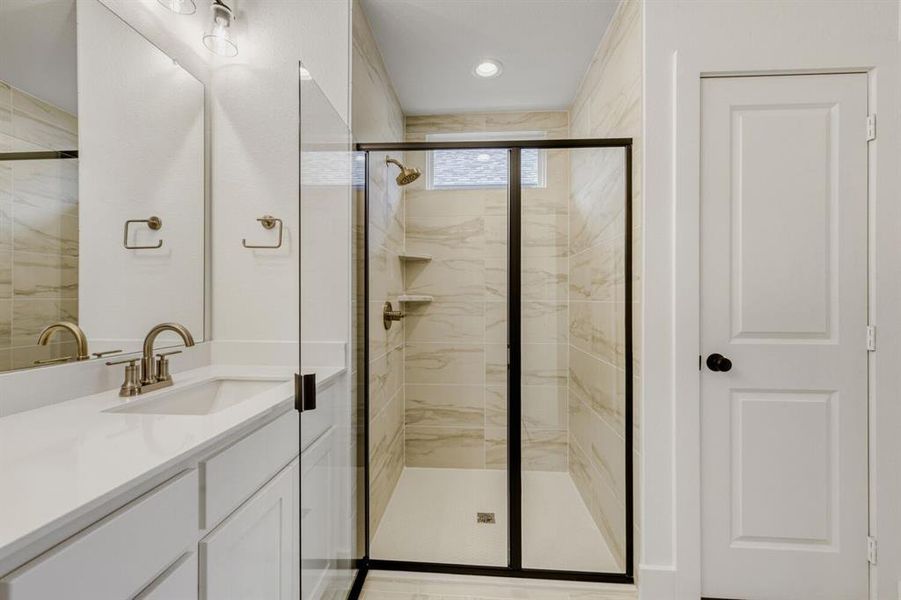 Full bath with vanity and a stall shower Full bath with vanity and a stall shower