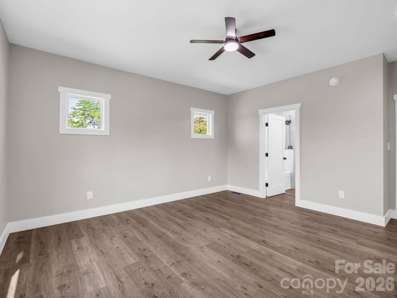 Primary bedroom, abundant natural light, hardwood floors Primary bedroom, abundant natural light, hardwood floors