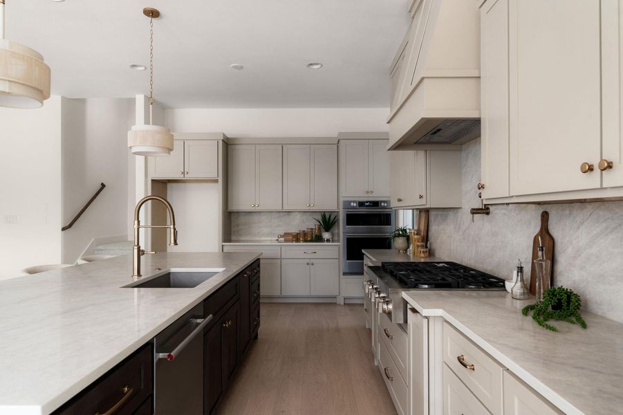Culinary excellence awaits in this well-lit kitchen, featuring a spacious island and top-tier appliances.