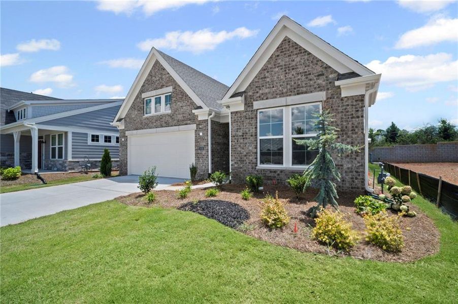Front exterior of a new home in Laurel Farms, Dallas, GA, highlighting curb appeal (Image 1).